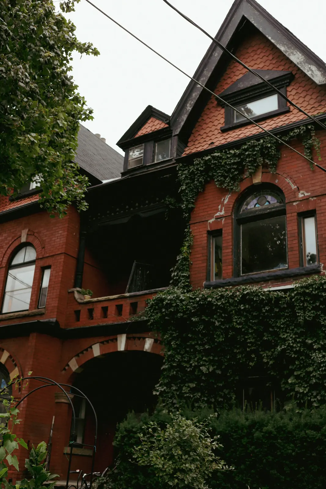 Red brick Victorian house with ivy and a tall brick chimney