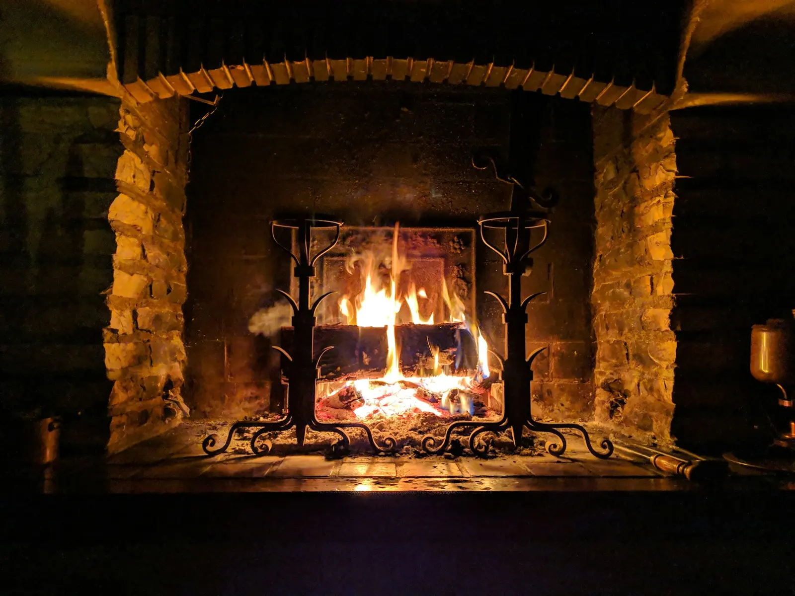 Wood fire burning in a stone fireplace